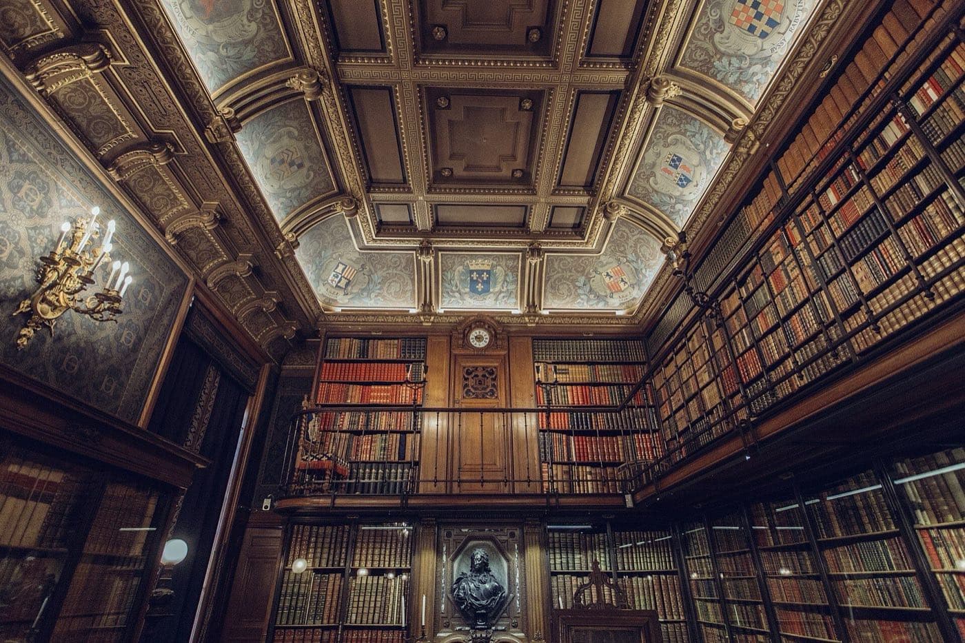 The ornate two-storey reading room of the library at the Château de Chantilly